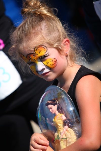 girl with face paint and princess toy